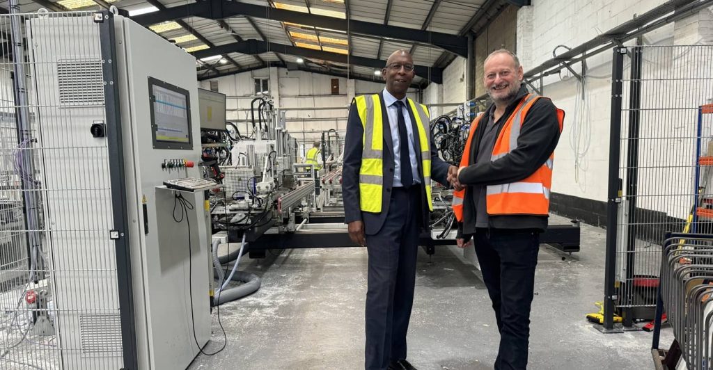 Kevin Noray, Sales Director of Winmac (left), and David Eagle, CEO of Genius PVC Trade Frames (right), shaking hands at the Genius factory.