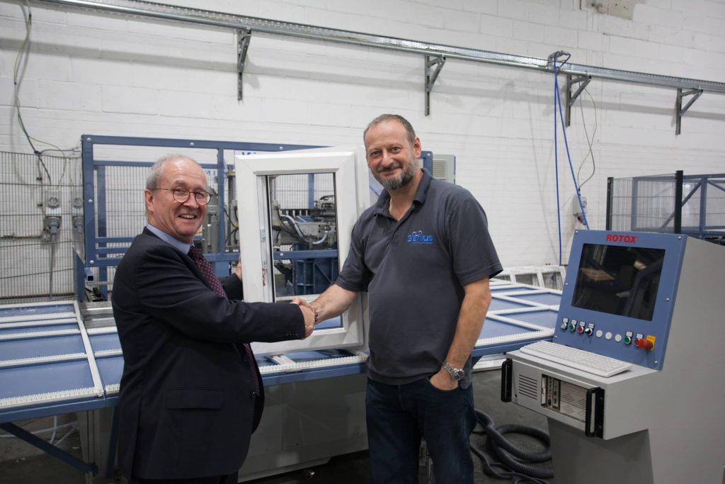 David Thornton from The Window Company (Contracts) shakes hands with Genius PVC Trade Frames CEO David Eagle at the Genius factory